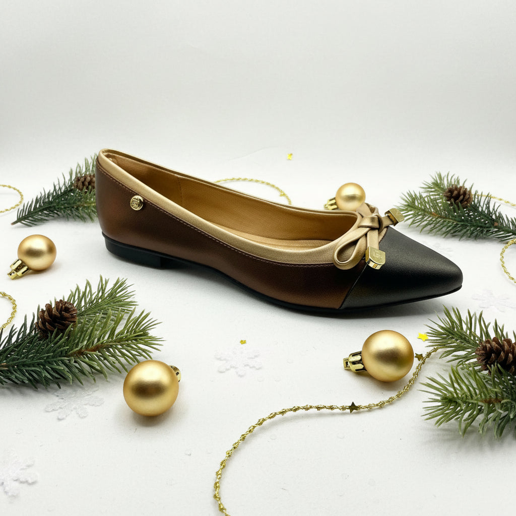 A pair of brown metallic Tasha Ballerina flats with a strap and buckle closure.