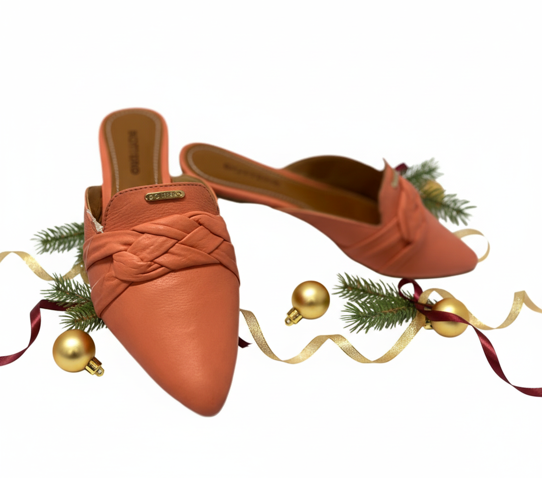 Pair of orange pointed-toe shoes with braided