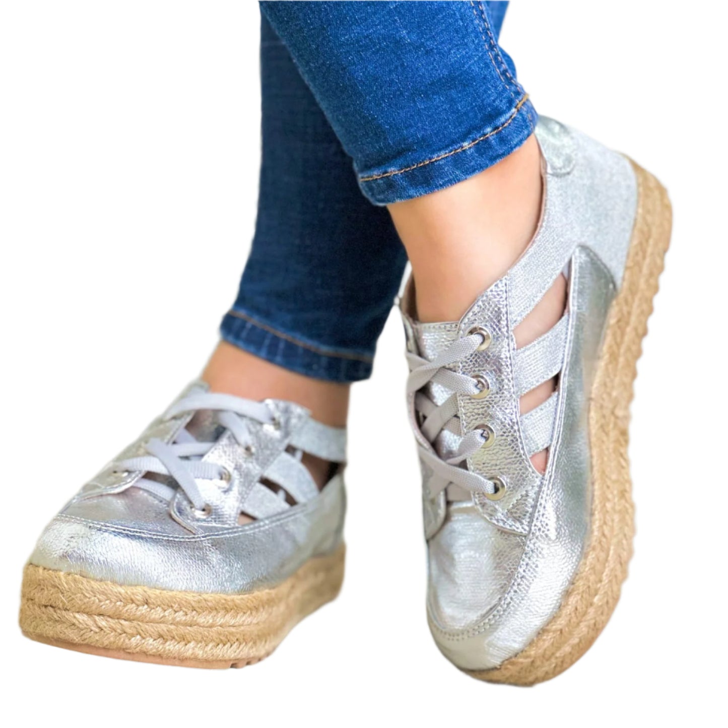 A pair of silver metallic women's sneakers with a jute platform sole,