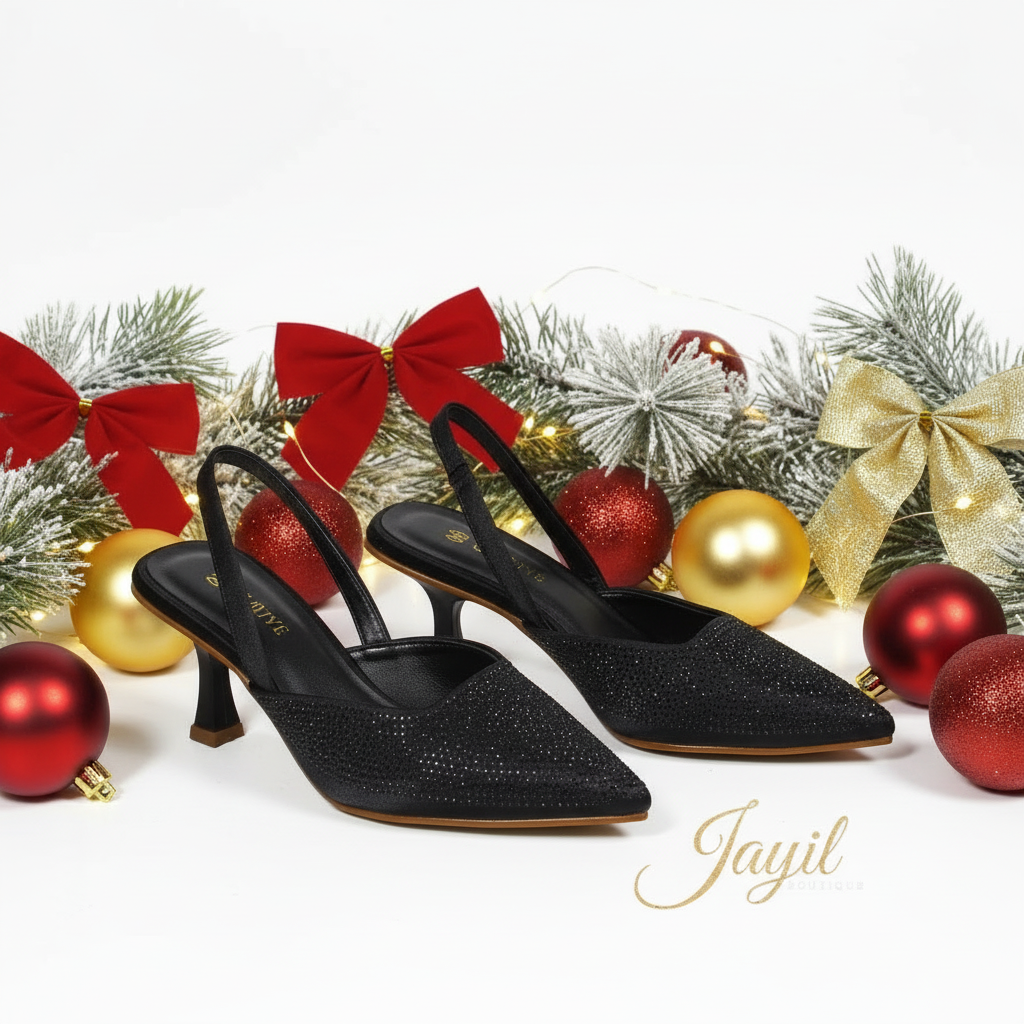 A pair of black kitten heel sandals with a textured surface.