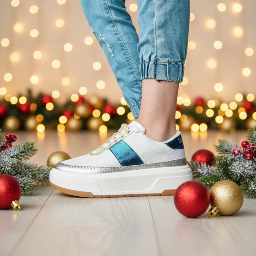 A white sneaker with blue metallic accents and a brown sole.