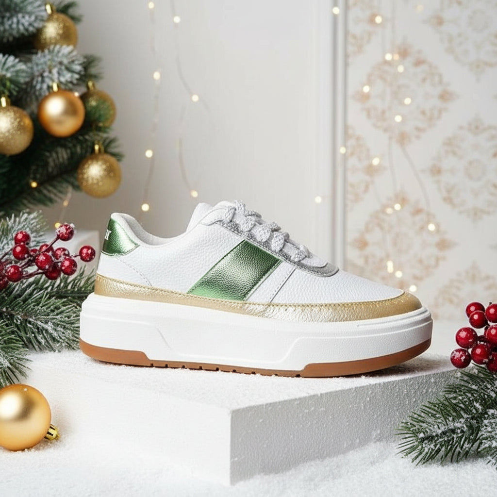 A platform tennis shoe with white uppers and green accents.