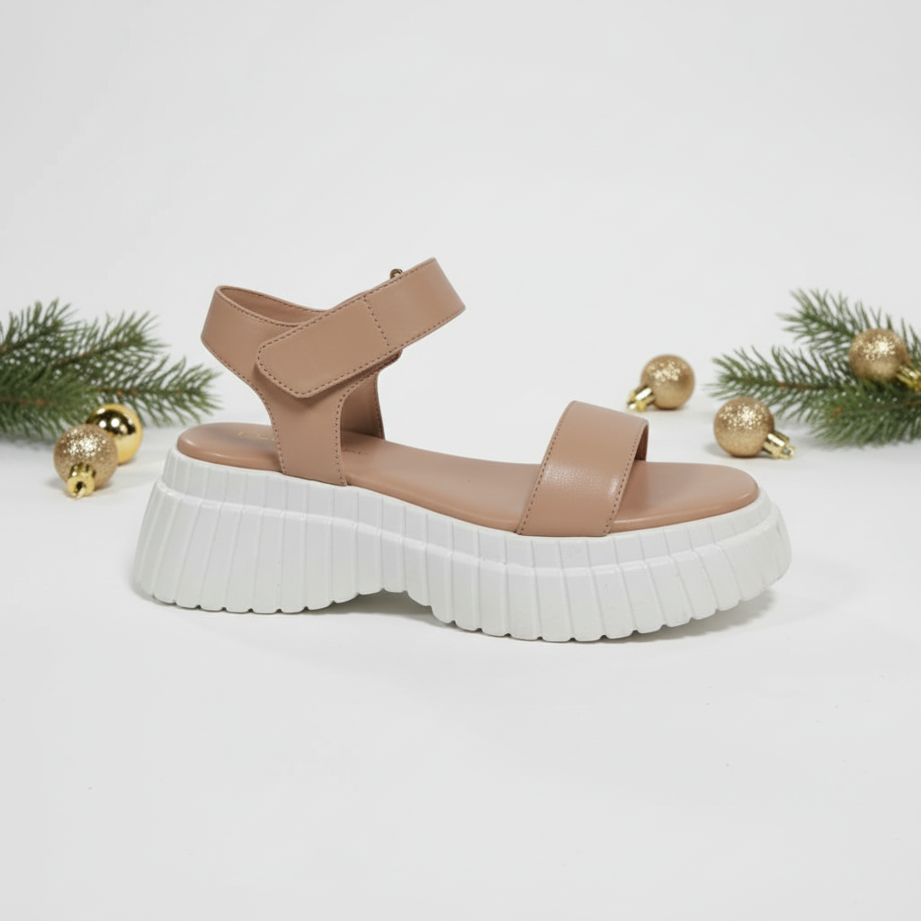 Tan sandal with a white sole.