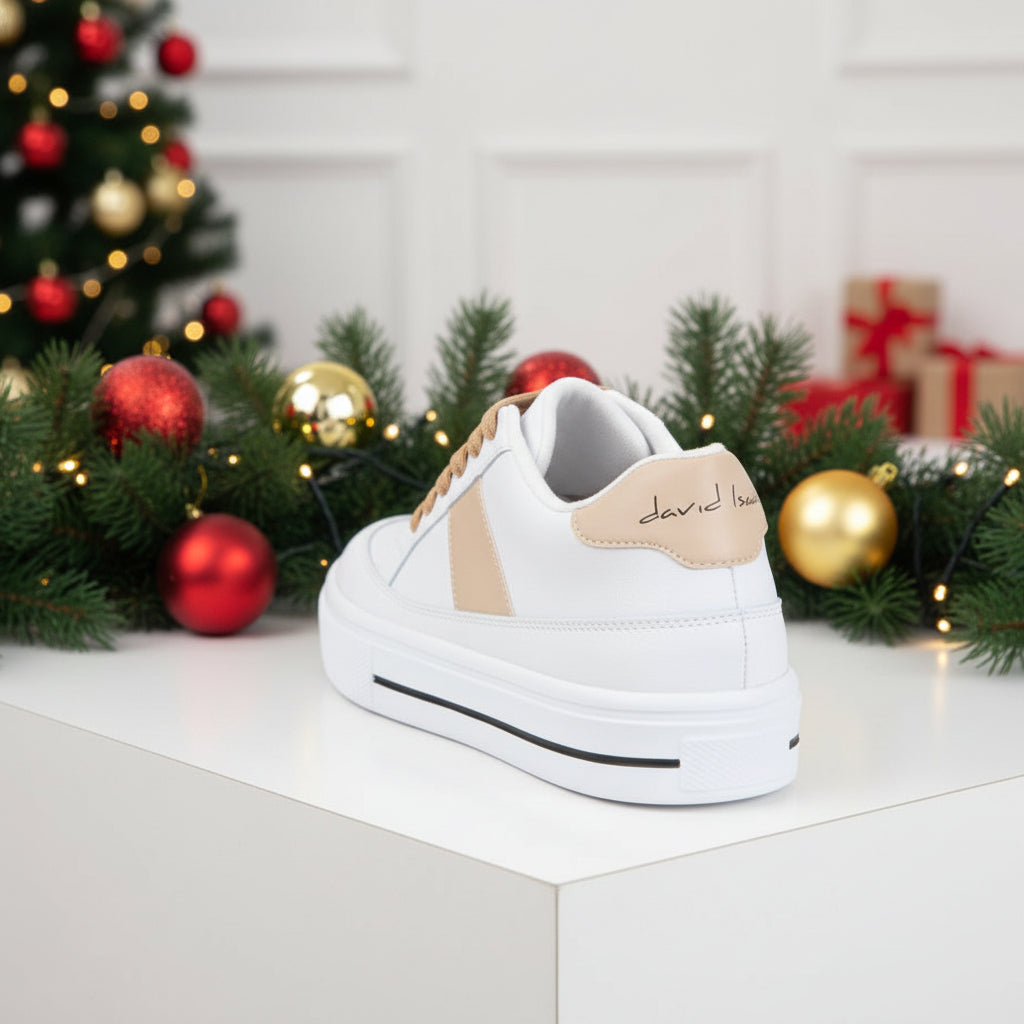 A pair of white and beige sneakers with lace-up closure and a rubber outsole.