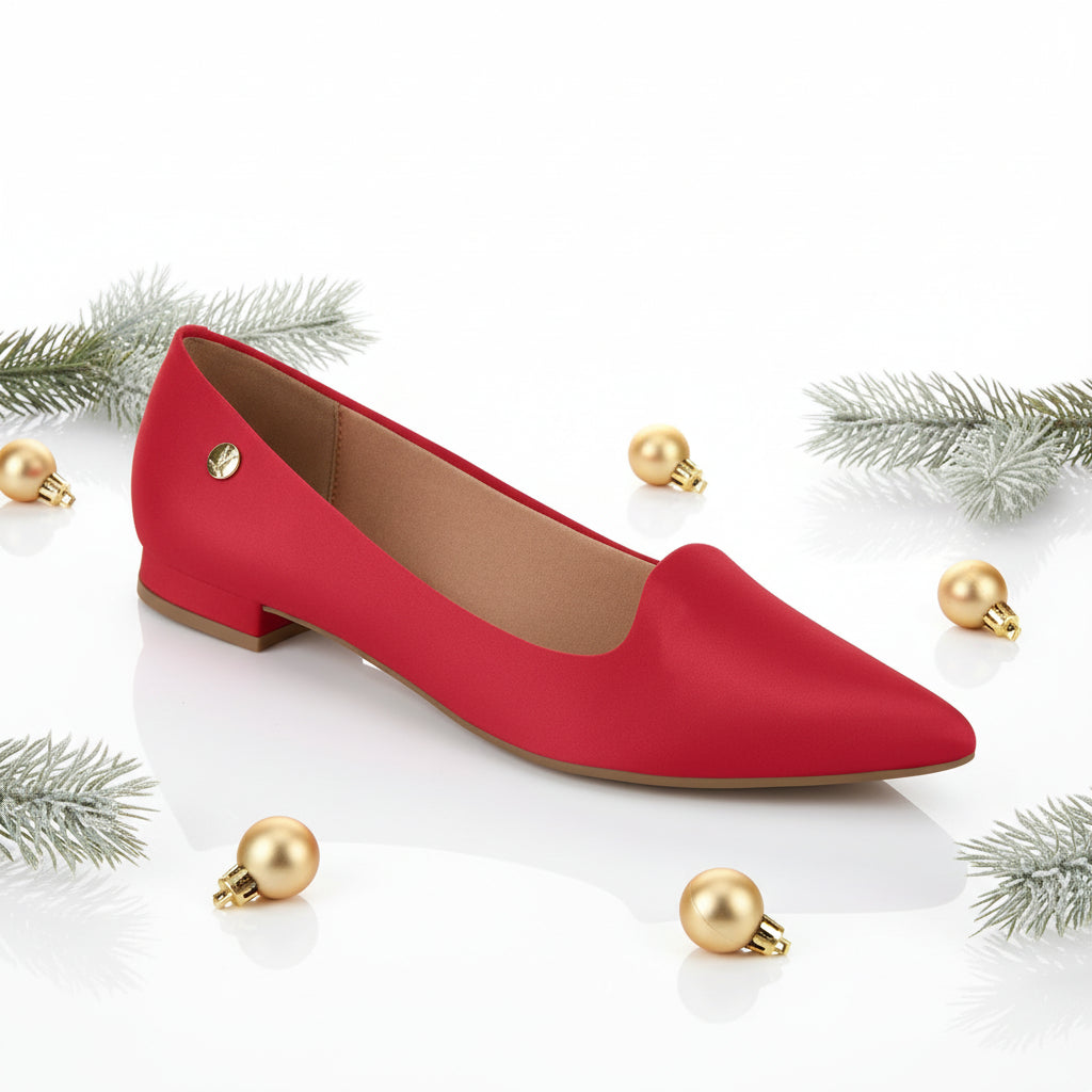 A single red flat shoe with a pointed toe and low heel.