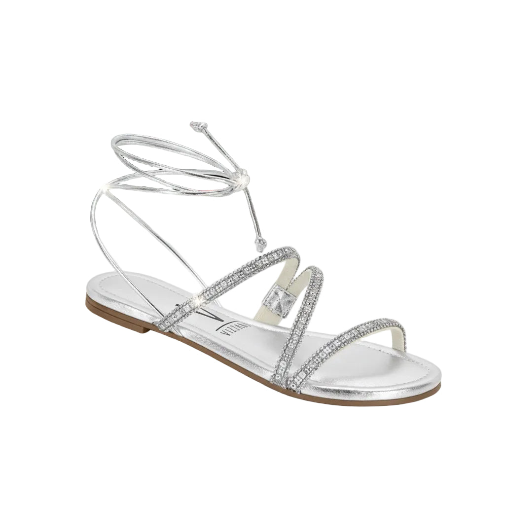 Silver sandal with rhinestone straps on a white surface