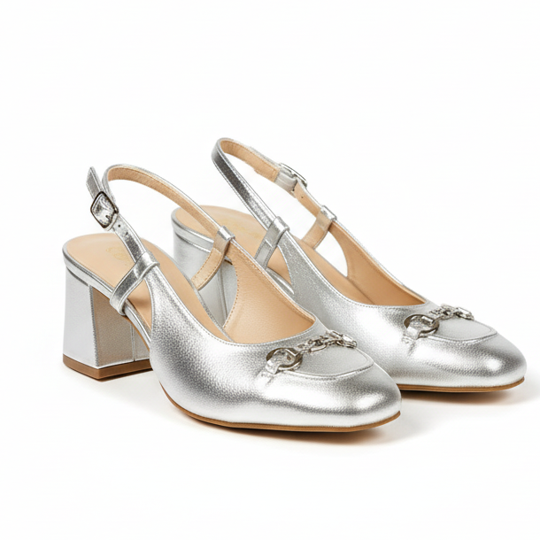 A silver heels with a square toe style and buckle strap details.
