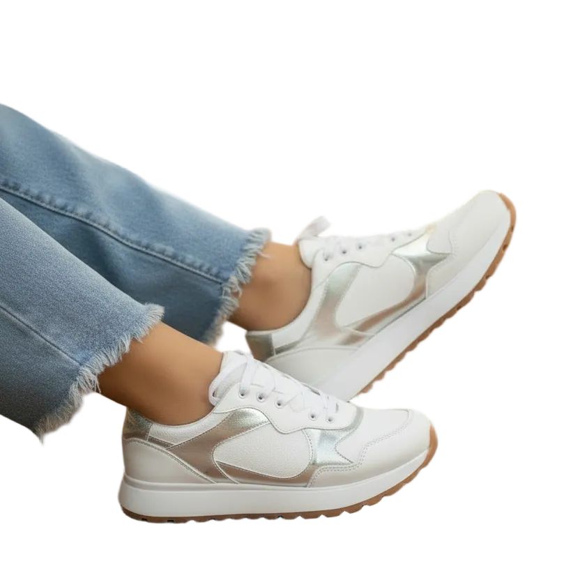 A pair of silver sneakers with white accents and silver detailing,.