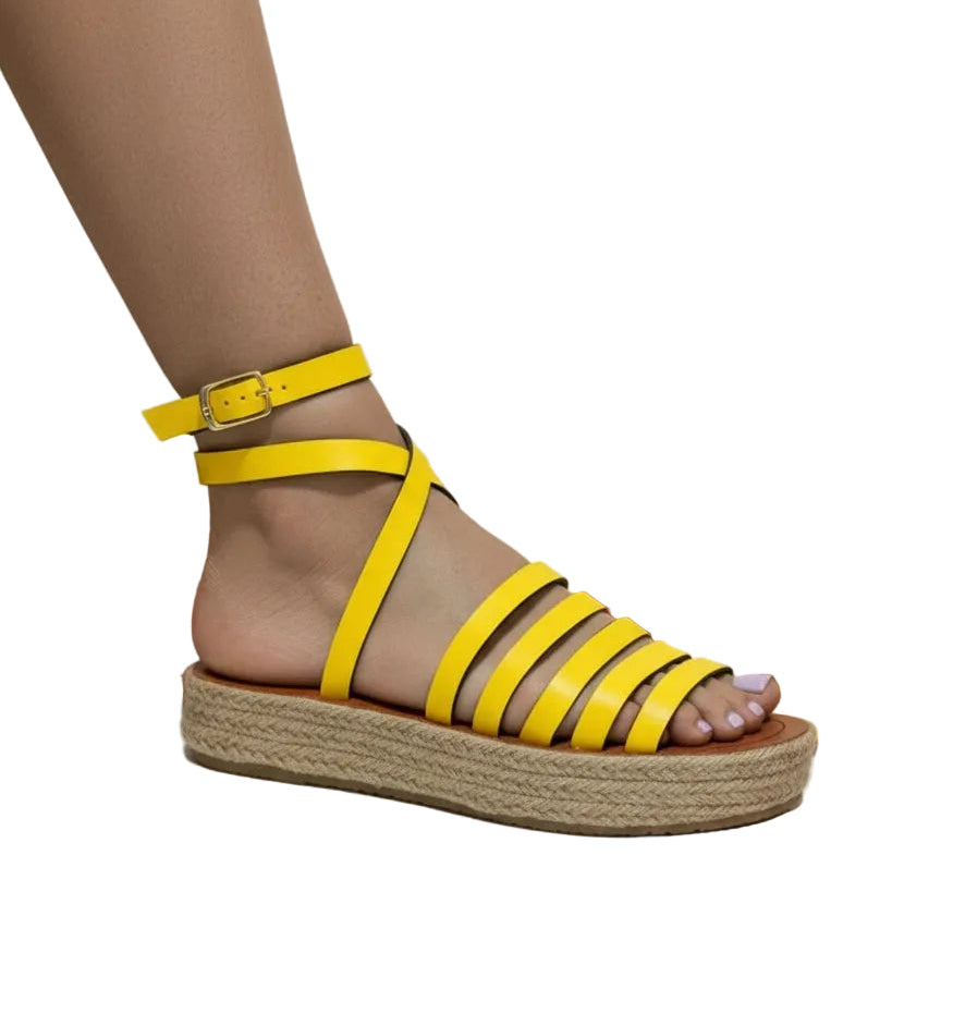 A yellow sandalia with a block heel and ankle strap.