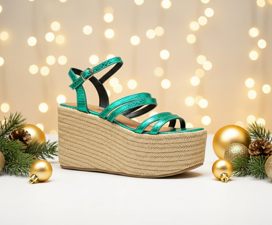 A green metallic platform wedge sandal with multiple straps and a jute-like heel.