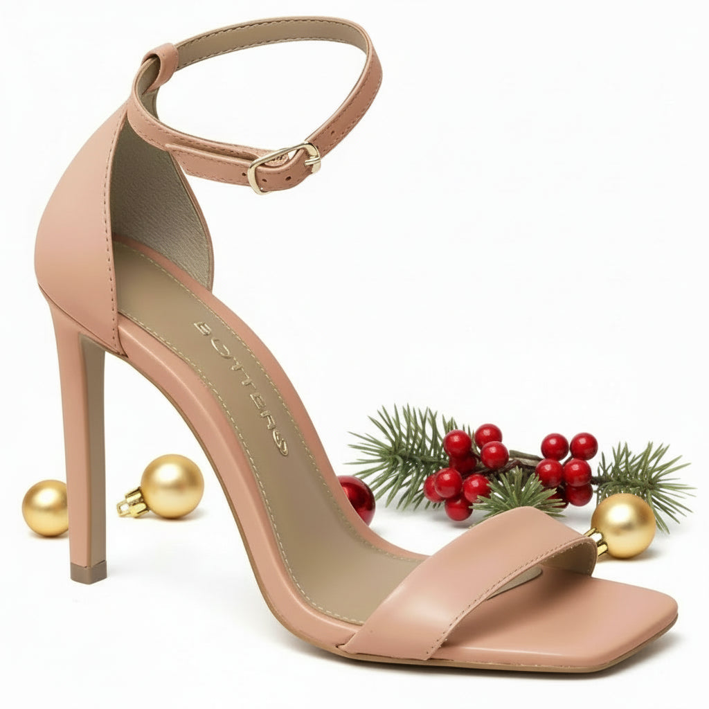 A beige high-heeled sandal with ankle strap, made from genuine leather,