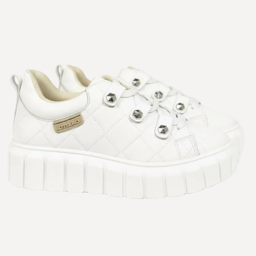 A pair of gray leather sneakers with a lace-up closure and a casual, chunky tread sole.