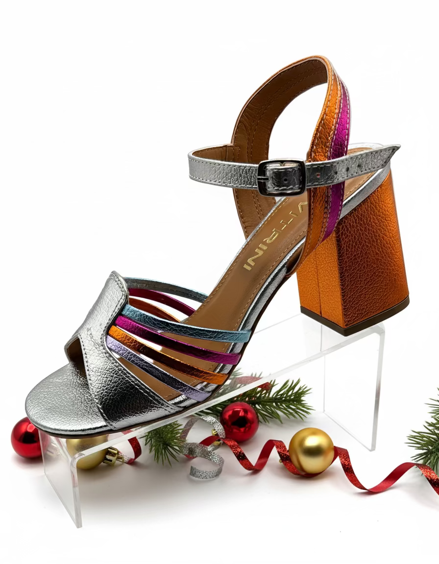 A metallic silver heel with orange and multicolored straps.