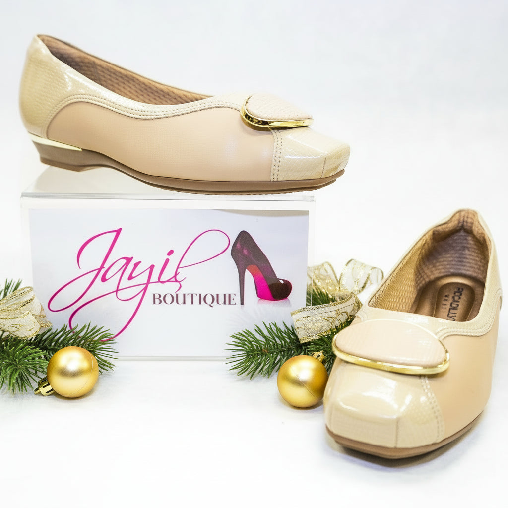 A pair of beige, pointed-toe flats.