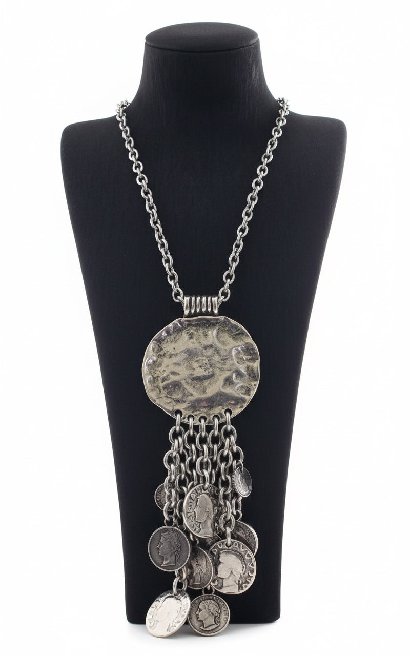 Silver necklace with circular pendant and chain.