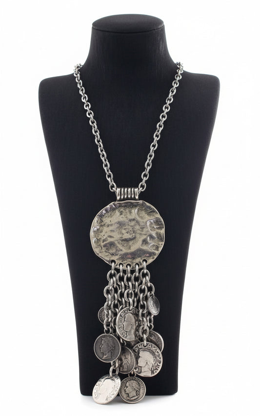 Silver necklace with circular pendant and chain.
