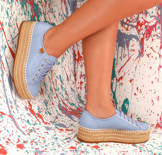 A pair of blue platform sneakers with white laces.