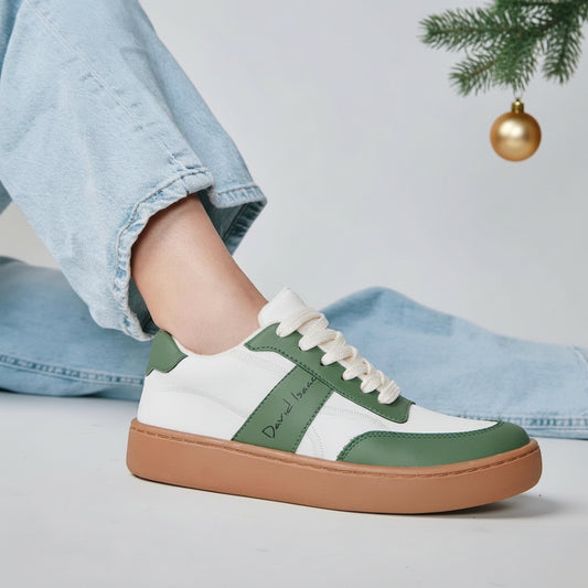 Green and white sneaker with brown sole.